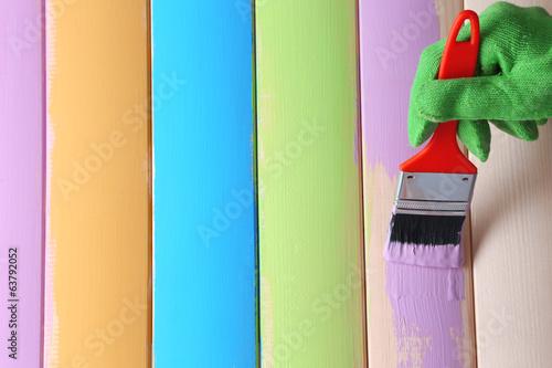 Photo: Brush painting wooden furniture, close up Brush painting wooden furniture, close up