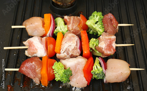 Photo: Pork kebab on grill close up Pork kebab on grill close up