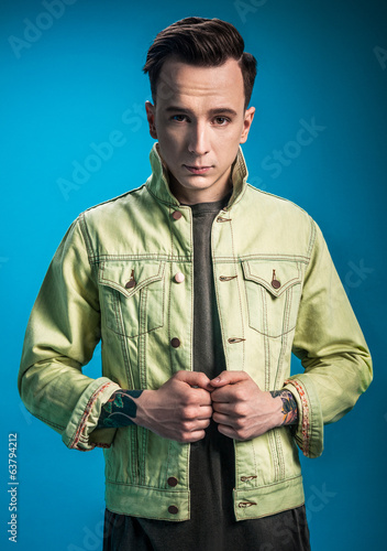 Photo: Stylish man on blue background Stylish man on blue background