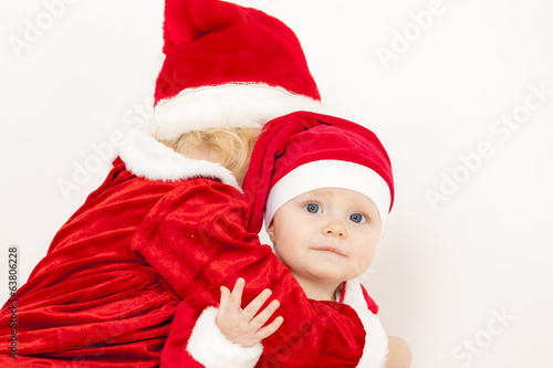 Photo: two little girls as Santa Clauses two little girls as Santa Clauses