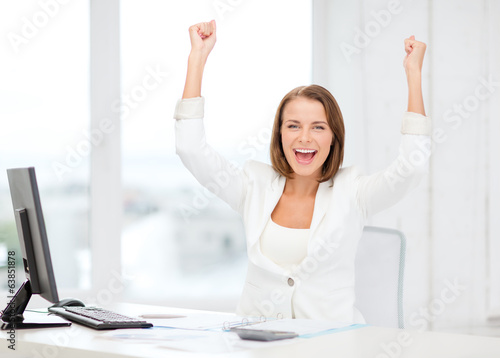 Photo: happy businesswoman with computer in office happy businesswoman with computer in office