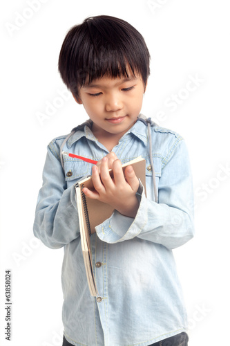 Photo: Boy writing on notebook Boy writing on notebook