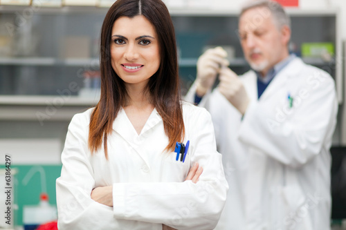 Photo: Couple of scientist researching in a laboratory Couple of scientist researching in a laboratory