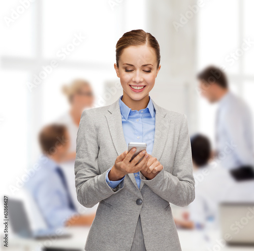 Photo: young smiling businesswoman with smartphone young smiling businesswoman with smartphone