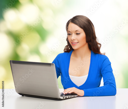 Photo: smiling woman in blue clothes with laptop computer smiling woman in blue clothes with laptop computer