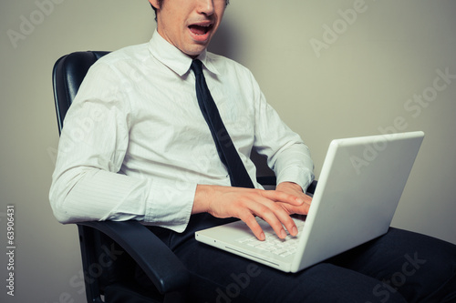 Photo: Excited businessman working on laptop Excited businessman working on laptop