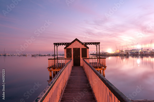 Photo: Beach cabin on San Pedro del Pinatar coast, Spain at sunset Beach cabin on San Pedro del Pinatar coast, Spain at sunset