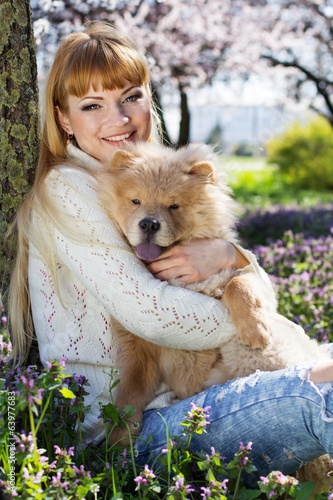 Photo: Portrait of a woman with her dog outdoors Portrait of a woman with her dog outdoors
