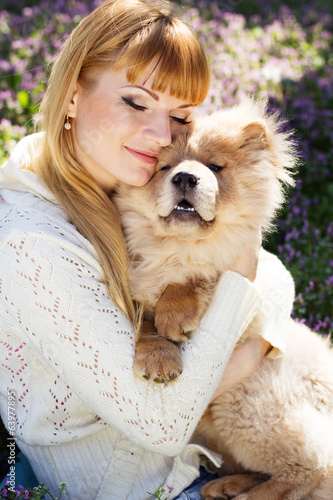 Photo: Portrait of a woman with her dog outdoors Portrait of a woman with her dog outdoors
