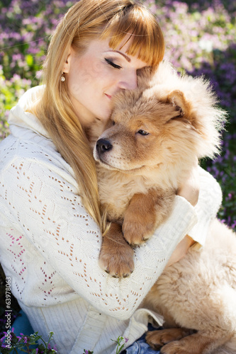 Photo: Portrait of a woman with her dog outdoors Portrait of a woman with her dog outdoors