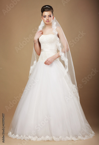 Photo: Wedding. Beautiful Graceful Bride in White Long Dress and Viel Wedding. Beautiful Graceful Bride in White Long Dress and Viel