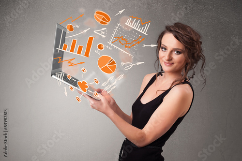 Photo: Beautiful lady holding notebook with graphs and statistics Beautiful lady holding notebook with graphs and statistics