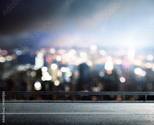 Photo: Asphalt road and blurred modern city Asphalt road and blurred modern city