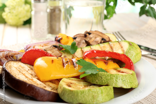 Photo: Delicious grilled vegetables on plate on table close-up Delicious grilled vegetables on plate on table close-up