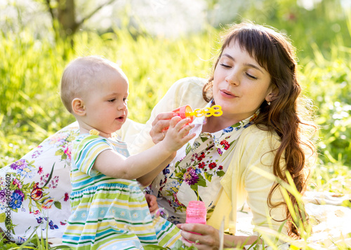 Photo: mother and kid girl having fun outdoors mother and kid girl having fun outdoors