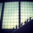 silhouettes man going up by escalator silhouettes man going up by escalator