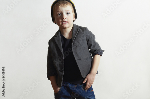 Photo: Fashionable little Boy in cap and jeans.Fashion Children Fashionable little Boy in cap and jeans.Fashion Children
