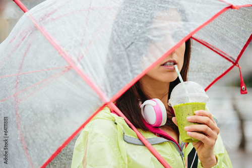 Photo: Fitness woman drinking detox smoothie Fitness woman drinking detox smoothie