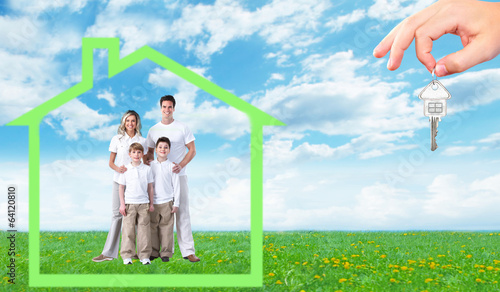 Photo: Happy family near new home. Happy family near new home.