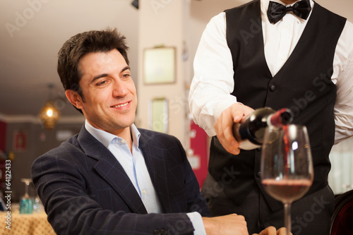 Photo: Waiter pouring wine Waiter pouring wine