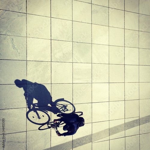 Instant Collection: Cycling man and his shadow in Berlin Cycling man and his shadow in Berlin