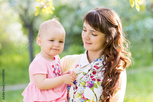 Photo: cute mother with baby girl outdoors cute mother with baby girl outdoors