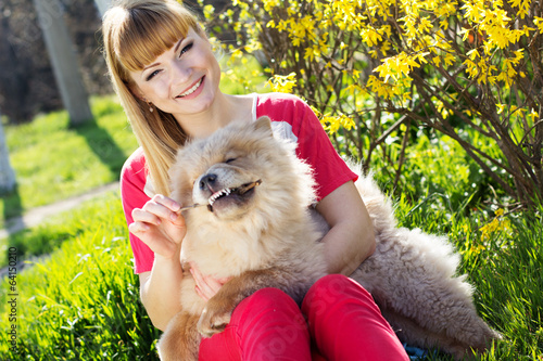 Photo: Portrait of a woman with her dog outdoors Portrait of a woman with her dog outdoors