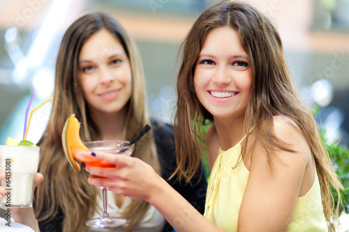 Photo: Two women having a drink Two women having a drink