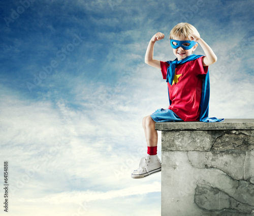 Photo: Super hero boy with raised fists Super hero boy with raised fists
