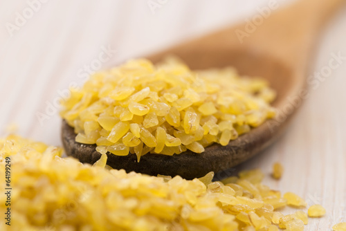 Photo: bulgur wheat in wooden spoon bulgur wheat in wooden spoon