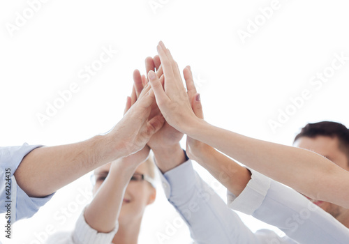 Photo: happy business team giving high five in office happy business team giving high five in office