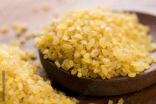 Photo: bulgur wheat in wooden spoon bulgur wheat in wooden spoon