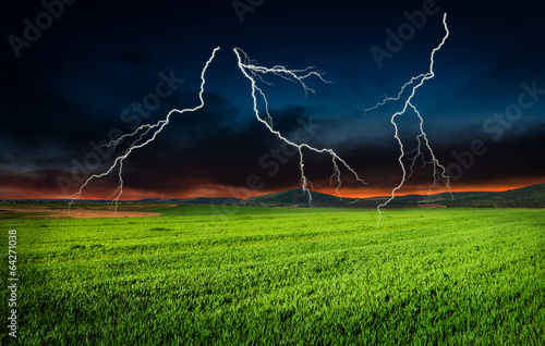 Photo: Thunderstorm with lightning in green meadow Thunderstorm with lightning in green meadow