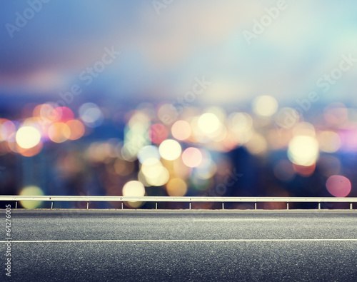 Photo: Asphalt road and blurred modern city Asphalt road and blurred modern city