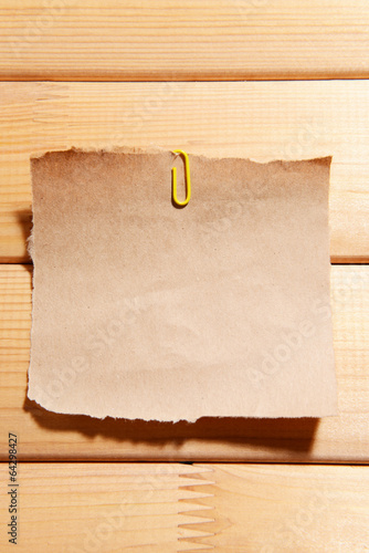 Photo: Empty paper sheet on wooden background Empty paper sheet on wooden background