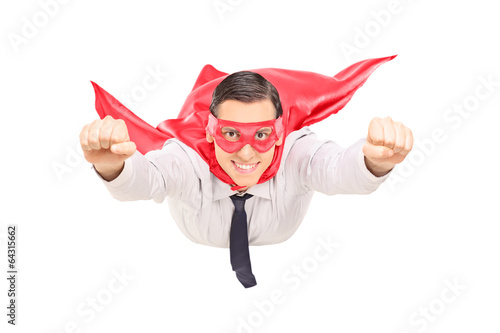 Photo: Superhero with red cape flying Superhero with red cape flying