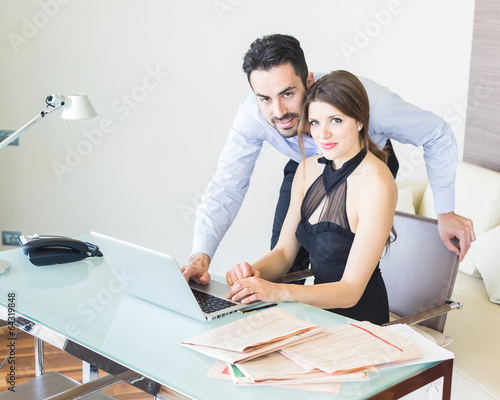 Photo: Business Couple Working at Office Business Couple Working at Office