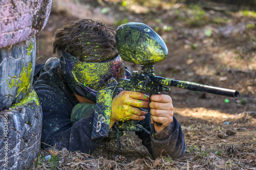 Photo: Paintball player in bright paint splashes Paintball player in bright paint splashes