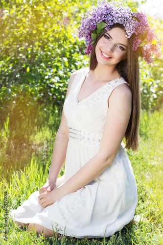 Photo: Beautiful girl with a lilac flowers Beautiful girl with a lilac flowers