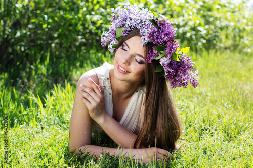 Photo: Beautiful girl with a lilac flowers Beautiful girl with a lilac flowers