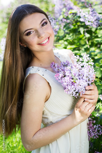 Photo: Beautiful girl with a lilac flowers Beautiful girl with a lilac flowers
