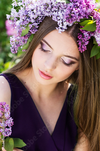 Photo: Beautiful girl with a lilac flowers Beautiful girl with a lilac flowers