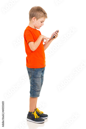 Photo: young boy using cell phone young boy using cell phone