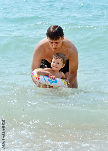 Photo: father and toddler daughter in the sea water father and toddler daughter in the sea water