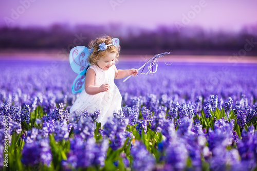 Photo: Adorable toddler girl in fairy costume in a flower field Adorable toddler girl in fairy costume in a flower field
