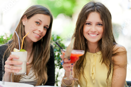Photo: Two girls having an aperitif outdoor Two girls having an aperitif outdoor