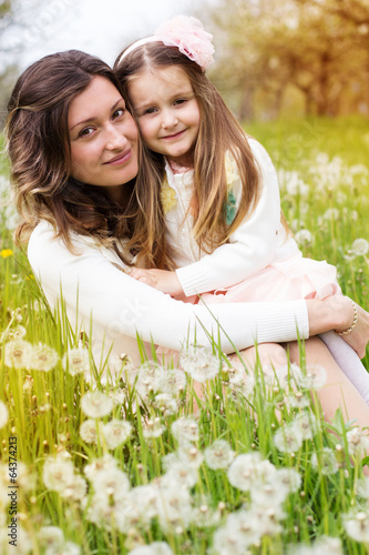 Photo: Mother and daughter in field with dandelions Mother and daughter in field with dandelions