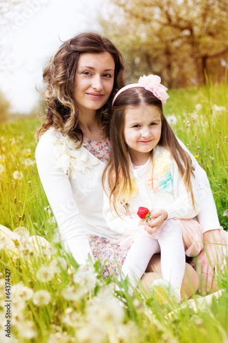Photo: Mother and daughter in field with dandelions Mother and daughter in field with dandelions