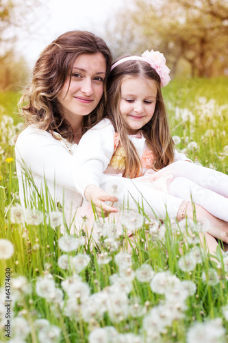 Photo: Mother and daughter in field with dandelions Mother and daughter in field with dandelions