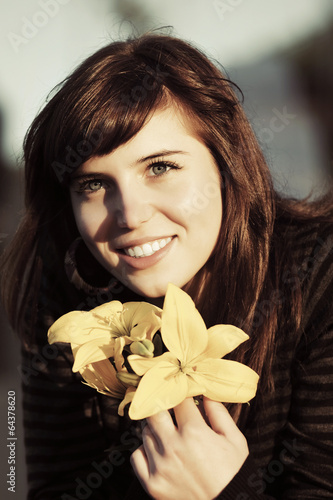 Photo: Happy young woman with a flowers Happy young woman with a flowers